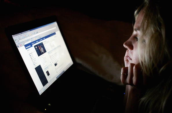 Girl browses the social networking site Facebook Girl browses the social networking site Facebook
